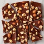 delicious batch of homemade brownie brittle topped with crunchy almonds and hazelnuts. This rich and crispy brownie brittle recipe is the perfect chocolate treat for snack lovers.