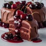 Indulgent Chocolate Cherry Cake Recipe – A moist chocolate layer cake covered in creamy chocolate frosting, drizzled with a rich cherry sauce, and topped with fresh cherries. A perfect dessert for chocolate and cherry lovers.