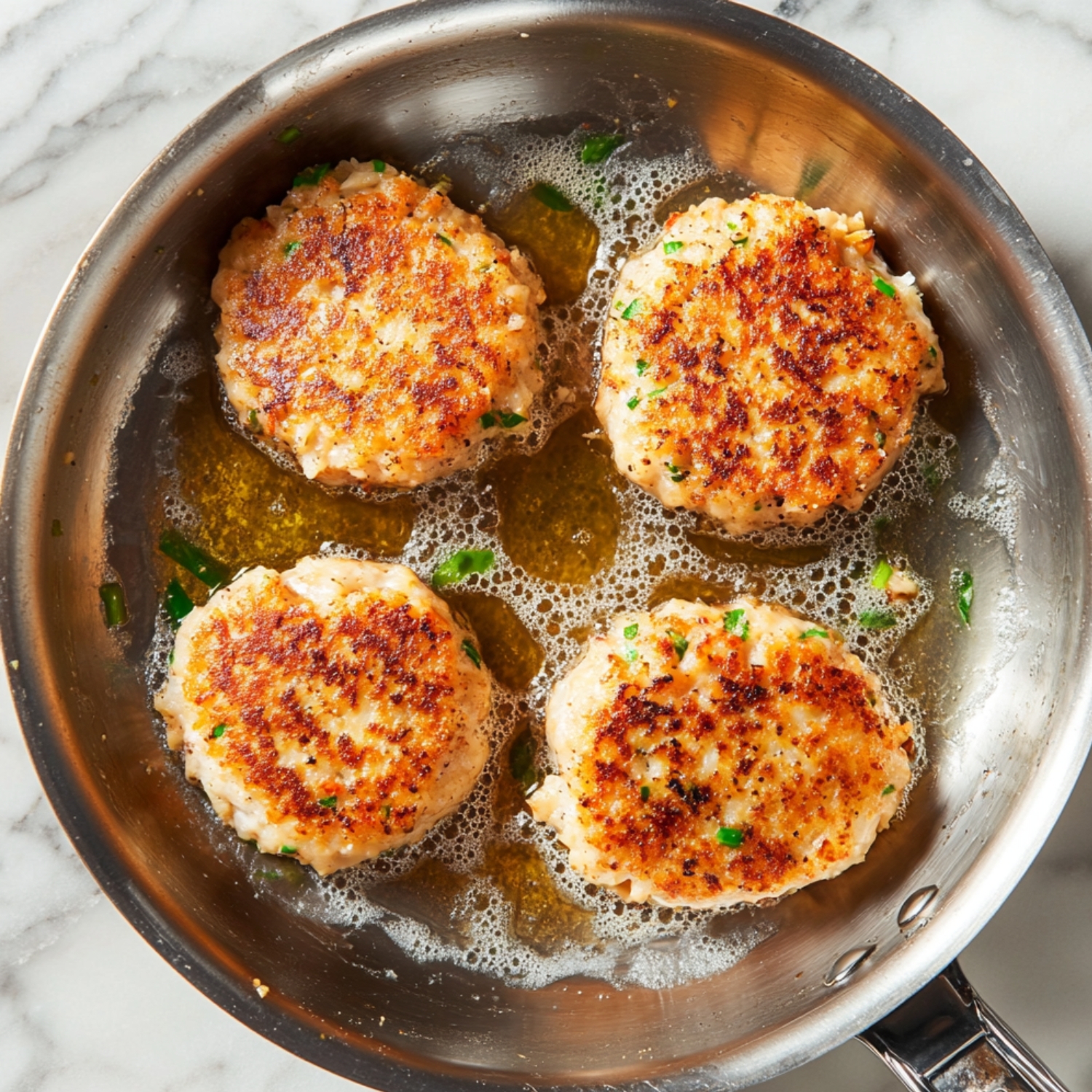 Heat butter in a skillet over medium heat. Cook patties in the skillet until golden brown, 5 to 6 minutes on each side.