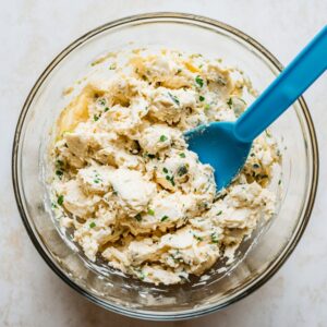 Gradually mix in cracker crumbs, adding until desired consistency is achieved.