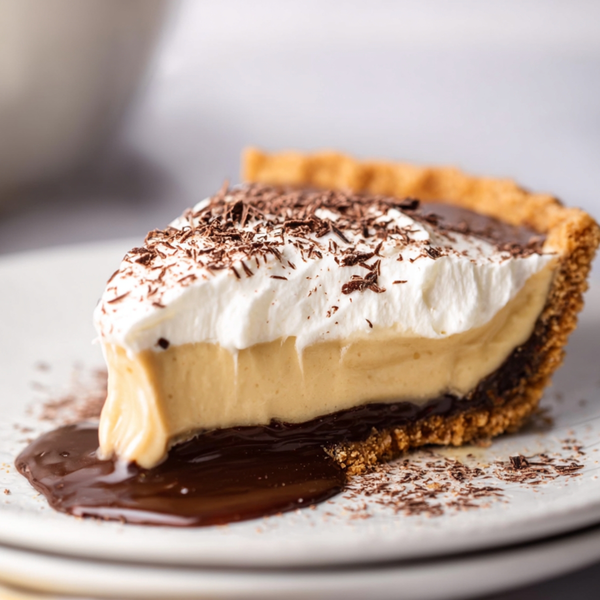 Easy Homemade Coffee Custard Pie Recipe with golden crust, dark base, creamy coffee filling, whipped cream topping, and cocoa dusting on a white plate with green rim.