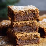 Gingerbread Brownies with a fudgy, moist center and crackly sugar top, lightly dusted with powdered sugar.