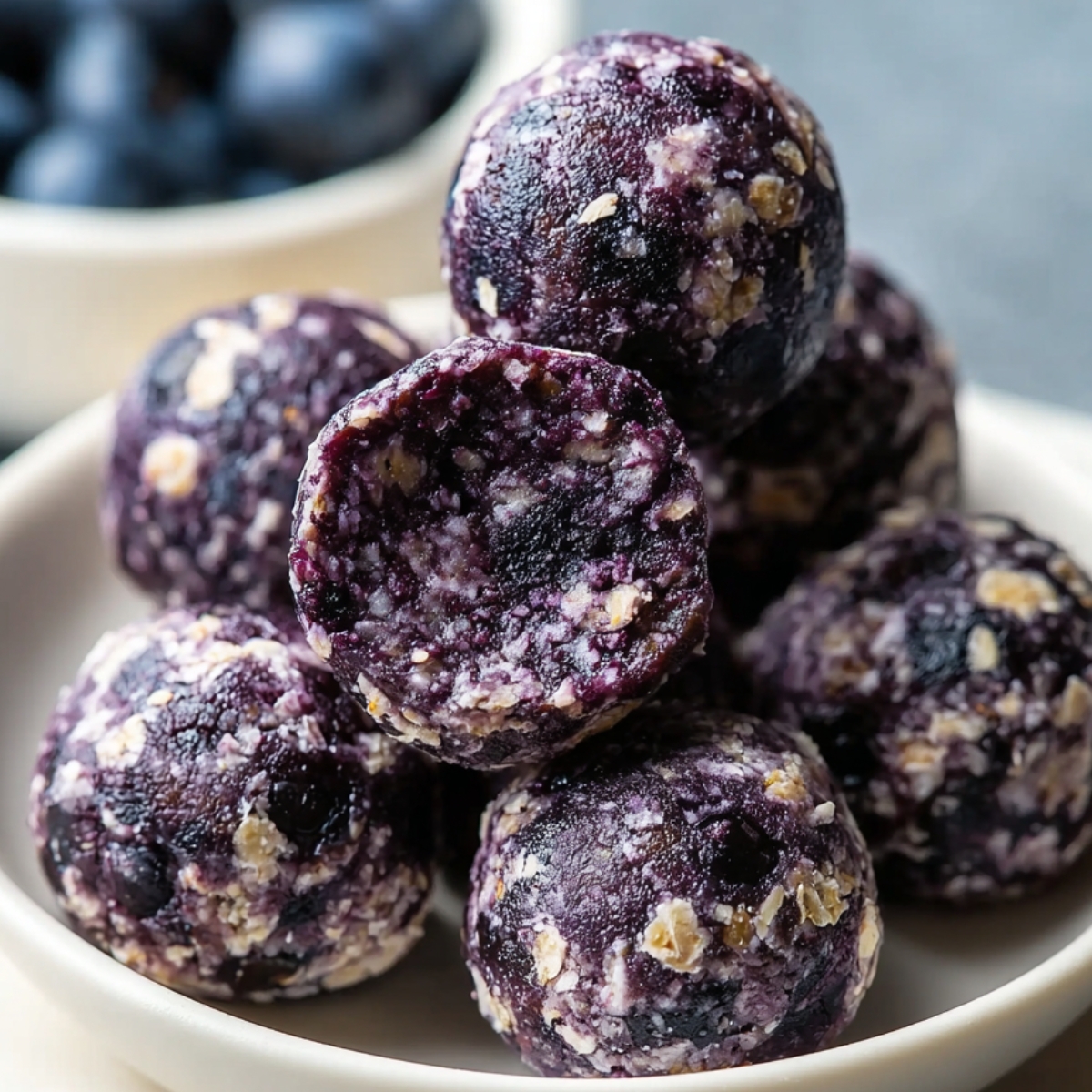 Homemade Blueberry Protein Balls, showing their natural mix of oats, almond butter, blueberries, and coconut flakes.