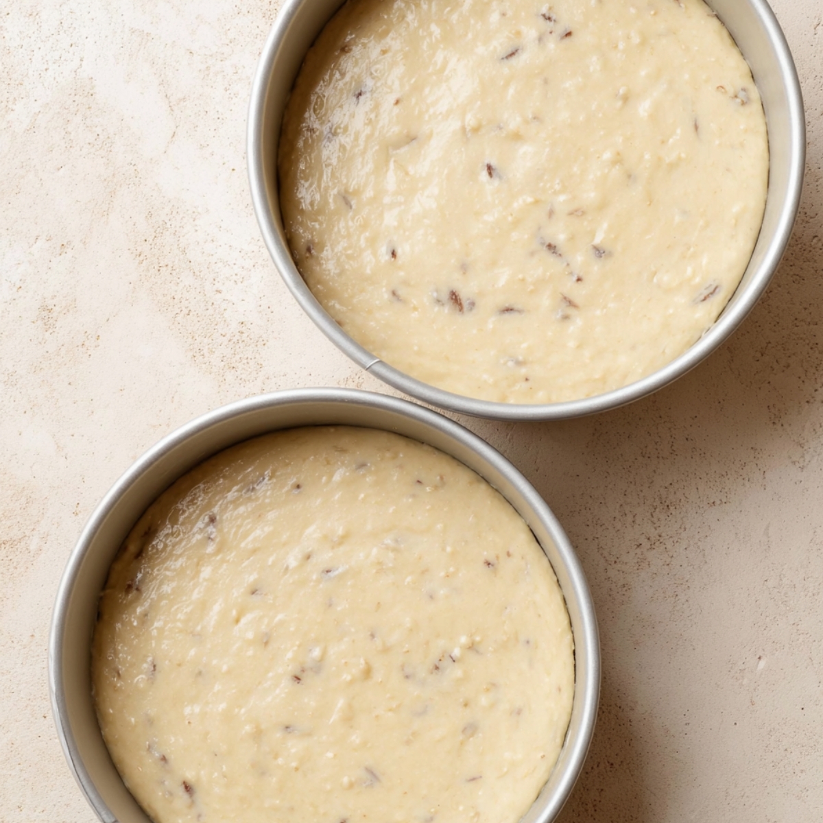 Divide the batter evenly among your three prepared pans, about 380-400 g per pan if you want to be precise. Bake for 21-23 minutes, until a toothpick inserted in the center comes out clean or with just a few moist crumbs.