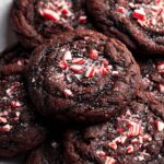 Close-up of homemade chocolate peppermint cookies topped with crushed candy canes.