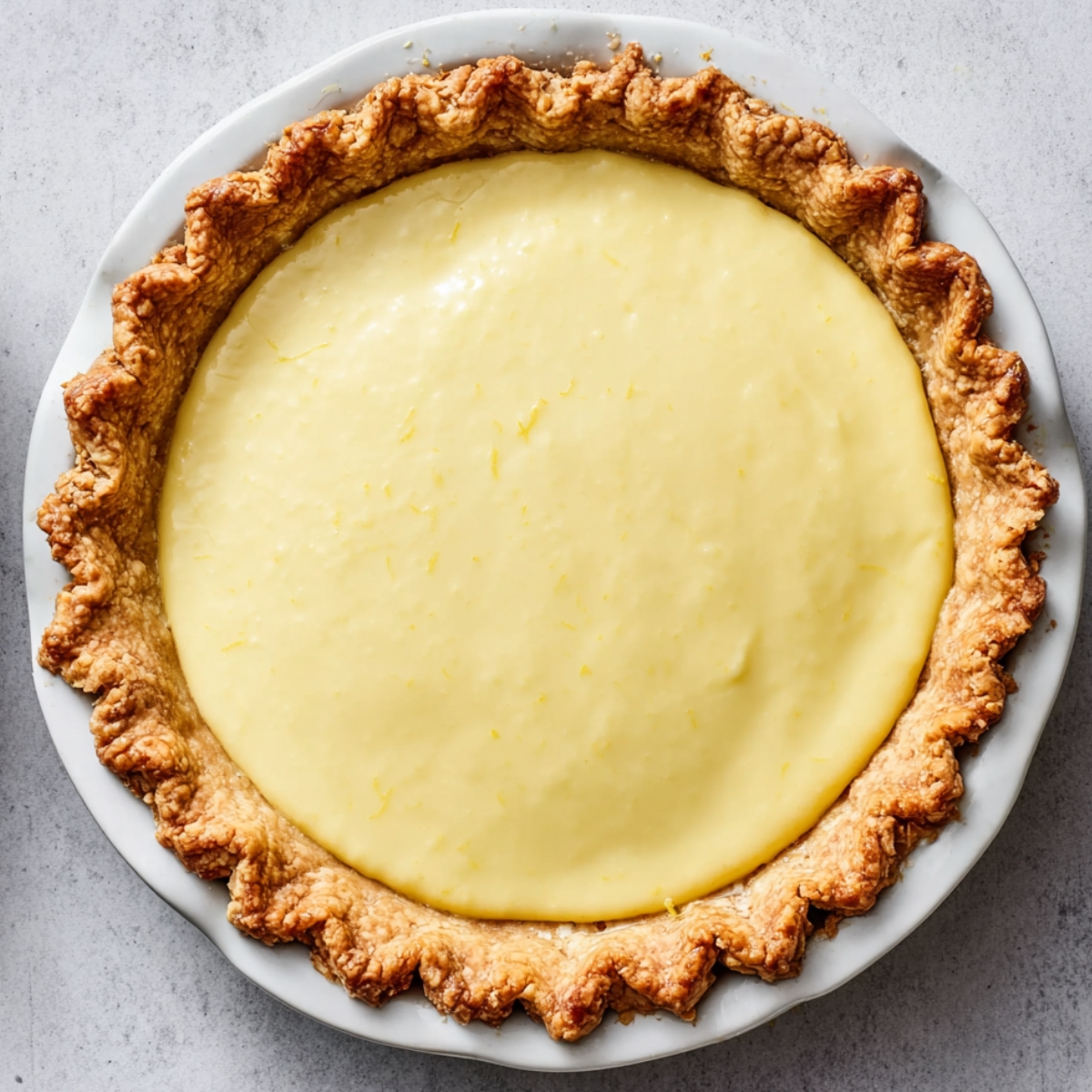 Pour the lemon filling into your pre-baked pie shell and smooth the top with a spatula.