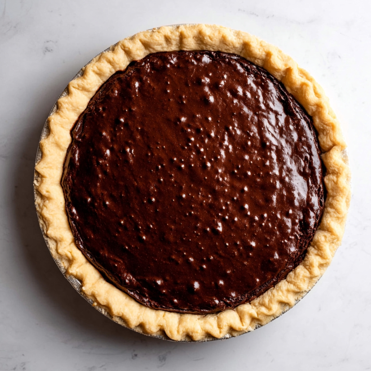 3-Ingredient Chocolate Brownie Pie That's Dangerously Easy! 12 Spoon the brownie batter into the unbaked pie shell, spreading it out gently with the back of your spoon so it reaches the edges.