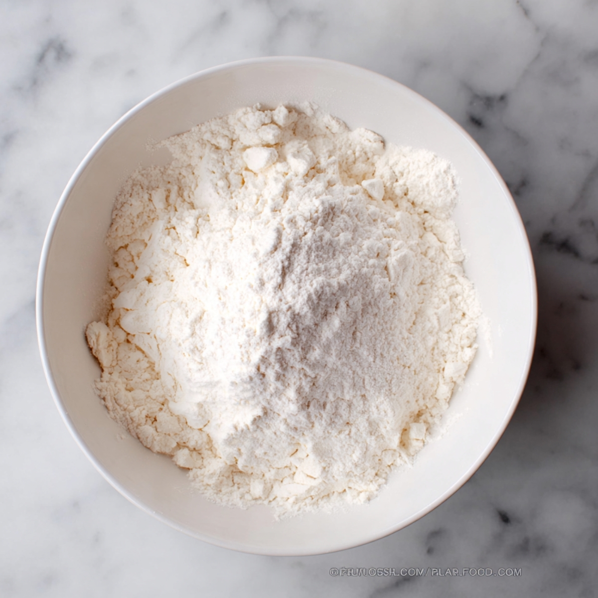 In a medium bowl, whisk together the flour, baking powder, baking soda, and salt until everything is evenly distributed. This helps ensure your cookies have a consistent texture. Set this bowl aside for now.
