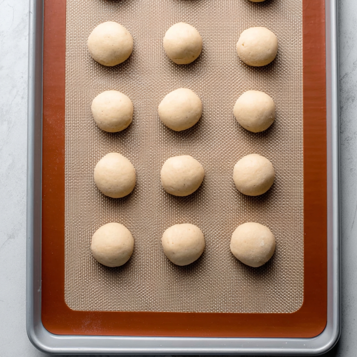 Scoop out about 1 tablespoon (20g) of dough for each cookie. Roll it between your palms into a ball. Don't stress if they're not perfect spheres, they'll still taste wonderful. Place them on your prepared baking sheets with at least 2 inches between each one.