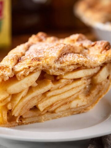 Easy Apple Cheddar Pie | Homemade Savory-Sweet Pie 6 Slice of Apple Cheddar Pie on a white plate showing layered apple filling and flaky golden crust