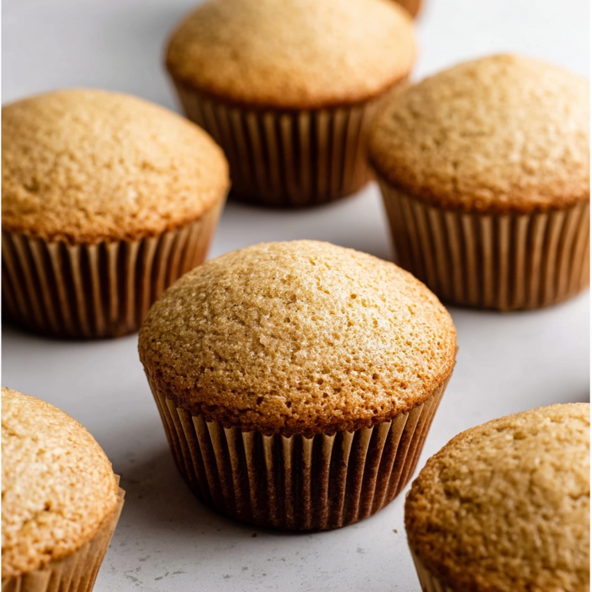 Delicious Baileys and Coffee Cupcakes 11 Freshly prepared, uncooked cupcake batter in paper liners, each one with a smooth, rounded top ready for baking.