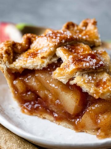 Homemade Caramel Pear Pie 15 Homemade Caramel Pear Pie with a golden lattice crust, showing a gooey, caramelized pear filling inside.