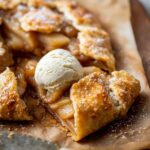 Homemade Ginger Pear Galette with a golden, flaky crust, topped with ice cream.