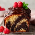 Marble Loaf Cake Recipe with raspberries on top.