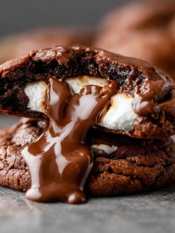 Easy Marshmallow Hot Cocoa Cookies 1 A close-up of a Marshmallow Hot Cocoa Cookies with a gooey melted marshmallow center oozing out.
