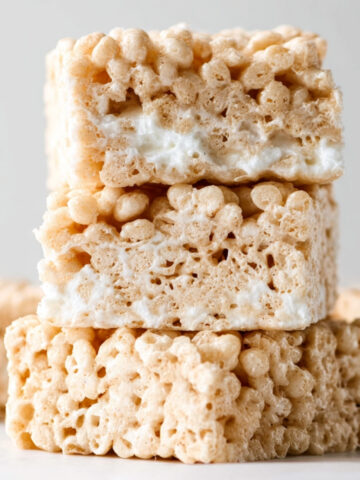 Soft and gooey Rice Krispie Treats stacked to show marshmallow layers and chewy texture