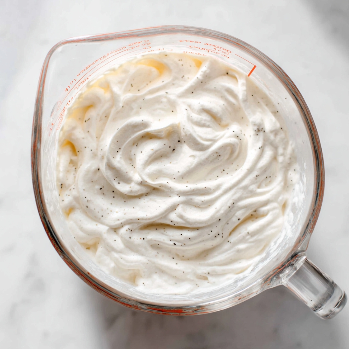 Easy Berry Icebox Cake Recipe 10 Vanilla bean whipped cream in a measuring cup, whipped until thick and fluffy.