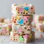 Stacks of White Chocolate Lucky Charms Treats with pastel-colored marshmallows.
