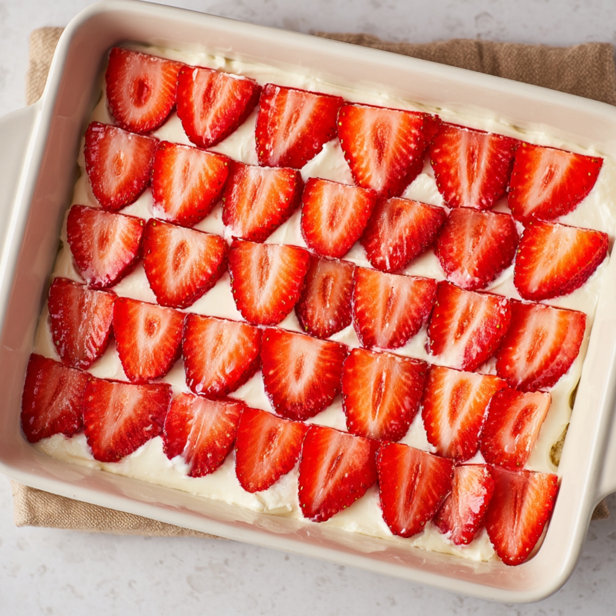 Easy Strawberry Icebox Cake Recipe 11 A smooth and creamy layer of whipped filling spread on top of the graham crackers in a strawberry icebox cake.