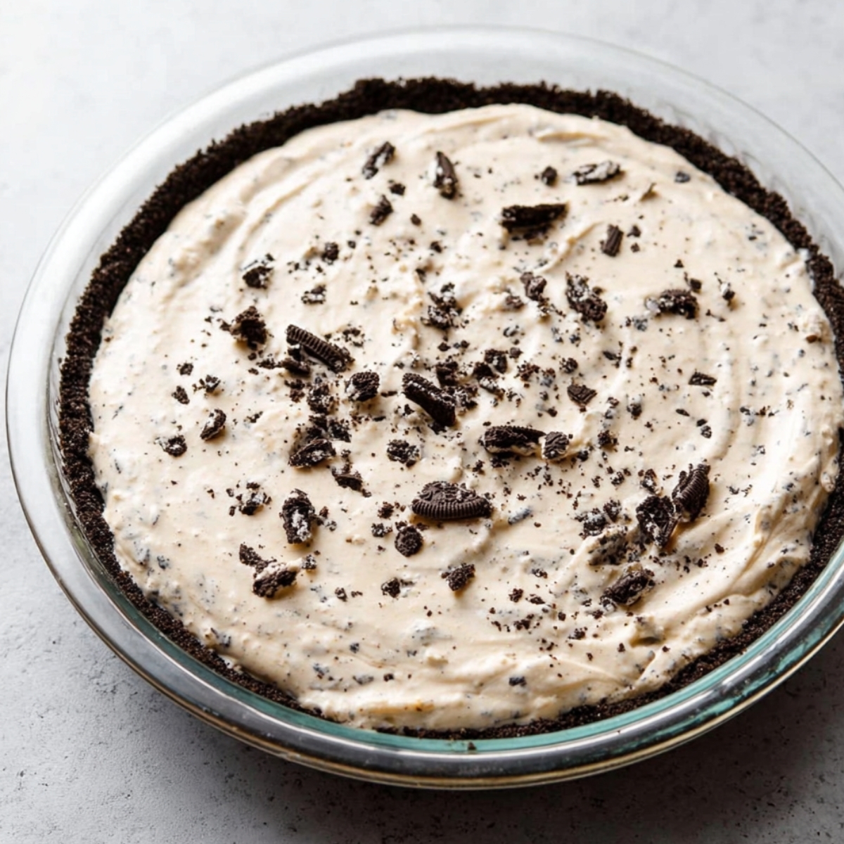 No-Bake Cookies and Cream Pie 12 Finished cookies and cream pie topped with whipped cream and Oreo crumbs
