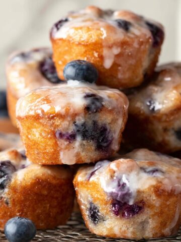 Baked Blueberry Fritter Bites, glazed with a sweet syrup, with visible blueberries peeking through the golden brown muffins.