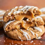Biscoff Lava Cookies broken in half, revealing caramel filling.