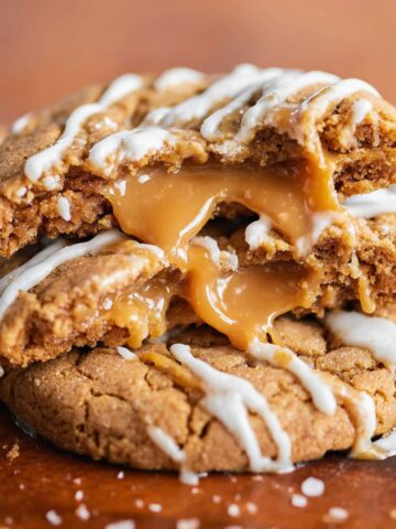 Chewy Biscoff Lava Cookies Recipe 1 Biscoff Lava Cookies broken in half, revealing caramel filling.