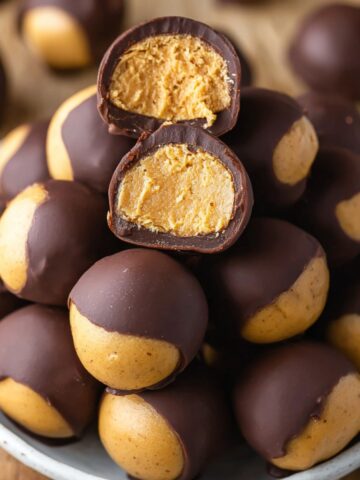 Easy Homemade Buckeyes Recipe 2 Close-up of homemade Buckeyes Recipe, chocolate-covered peanut butter balls with a bite taken out, showing the smooth peanut butter filling.