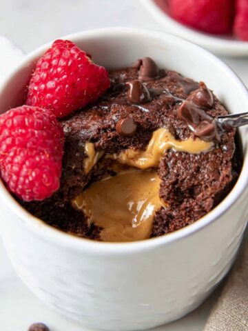 Best Chocolate Mug Cake Recipe 3 A warm, freshly baked Chocolate Mug Cake with a gooey peanut butter center, ready to be enjoyed with a spoonful of indulgence.