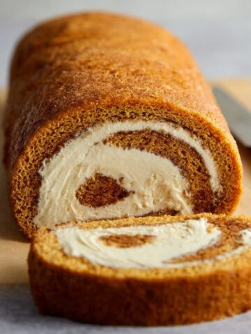 A freshly baked Coffee Swiss Roll with creamy filling, cut into slices.