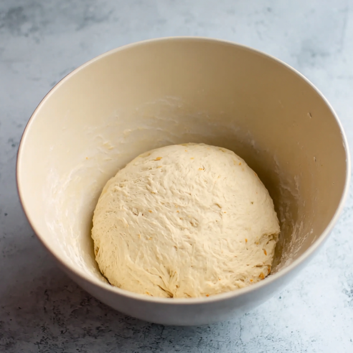 Homemade Orange Rolls Recipe 10 Dough ball after the first rise, now soft and smooth, ready for the next steps in making fresh orange rolls.