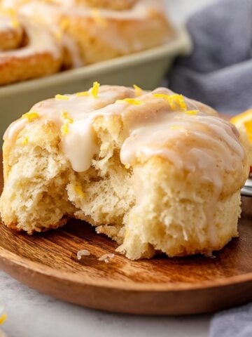 Homemade Orange Rolls Recipe 1 Freshly baked orange rolls with a sweet glaze, ready to be served. One roll has been bitten into to show its soft, airy interior.