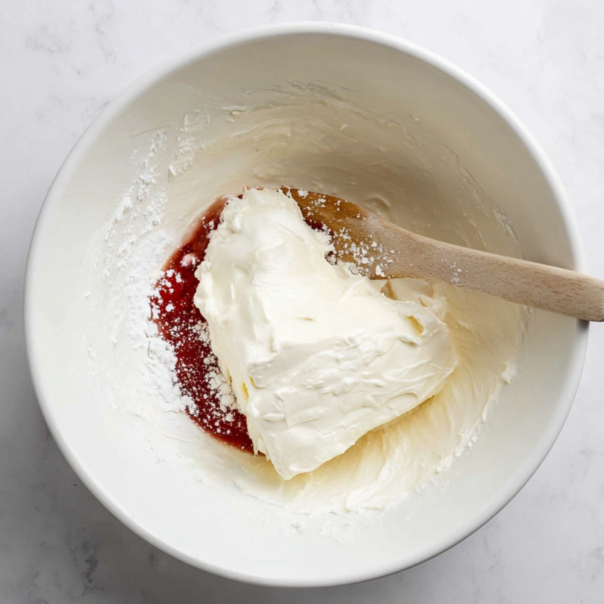 Easy Strawberry Pretzel Salad Recipe 10 Fresh strawberry slices soaking in a red gelatin mixture, ready to top a delicious dessert.