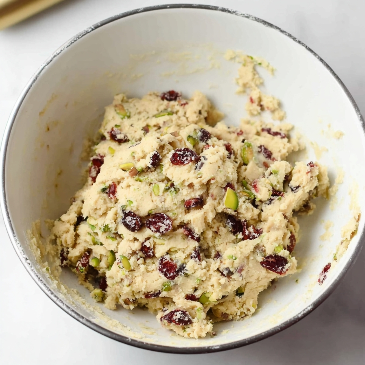Cranberry Pistachio Shortbread Cookies 10 Cranberry pistachio shortbread dough mixed together in a bowl.