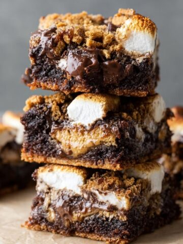 Fudgy S'mores Brownies Recipe 1 Stacked S'mores Brownies with gooey chocolate, marshmallows, and graham cracker crust, showcasing their delicious layers.
