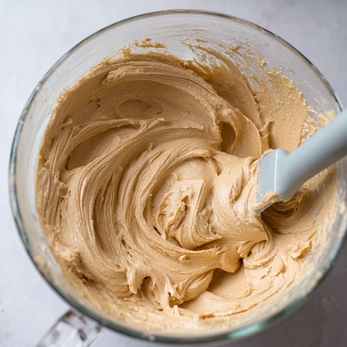 Easy Chocolate Snickers Cake Recipe 11 A creamy peanut butter buttercream frosting, whipped to a smooth and light texture, perfect for spreading on cakes or cupcakes.