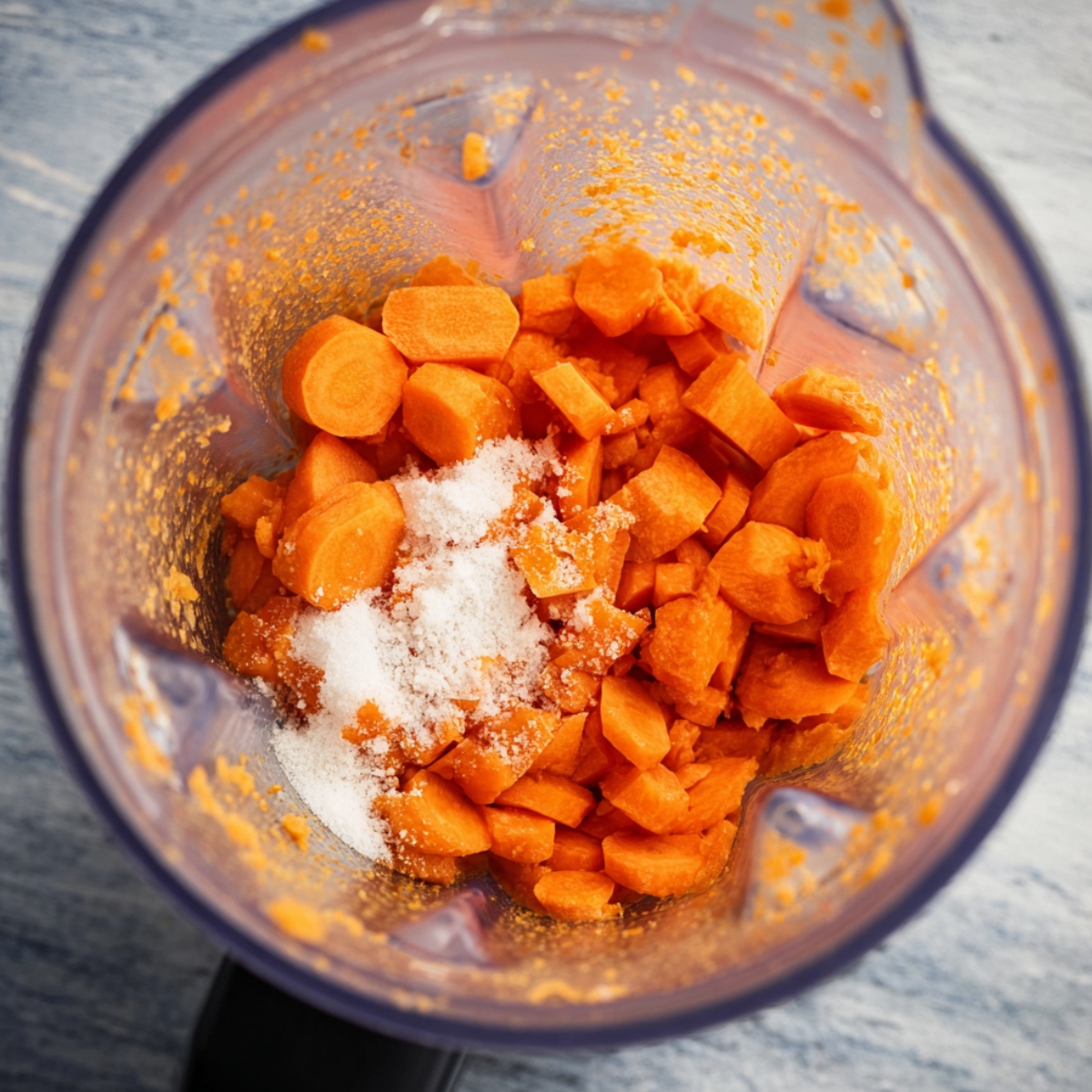 Easy Honey Carrot Pie Recipe 11 Chopped carrots and sugar placed in a blender, ready to be blended into a smooth mixture for a honey carrot pie filling.