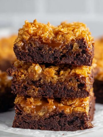 Easy Caramel Crunch Brownies 4 A stack of Caramel Crunch Brownies with a layer of crispy cornflakes on top, showing the rich, fudgy chocolate base.