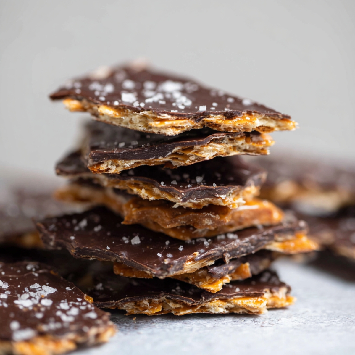 Easy Chocolate Matzo Crack Recipe 9 A stack of Chocolate Matzo Crack pieces with a crispy texture, sprinkled with sea salt.