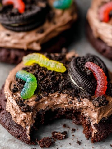 Easy Dirt Cake Cookies Recipe 1 Dirt Cake Cookies topped with creamy chocolate frosting, crumbled Oreo cookies, and gummy worms for a playful dirt cake-inspired look.