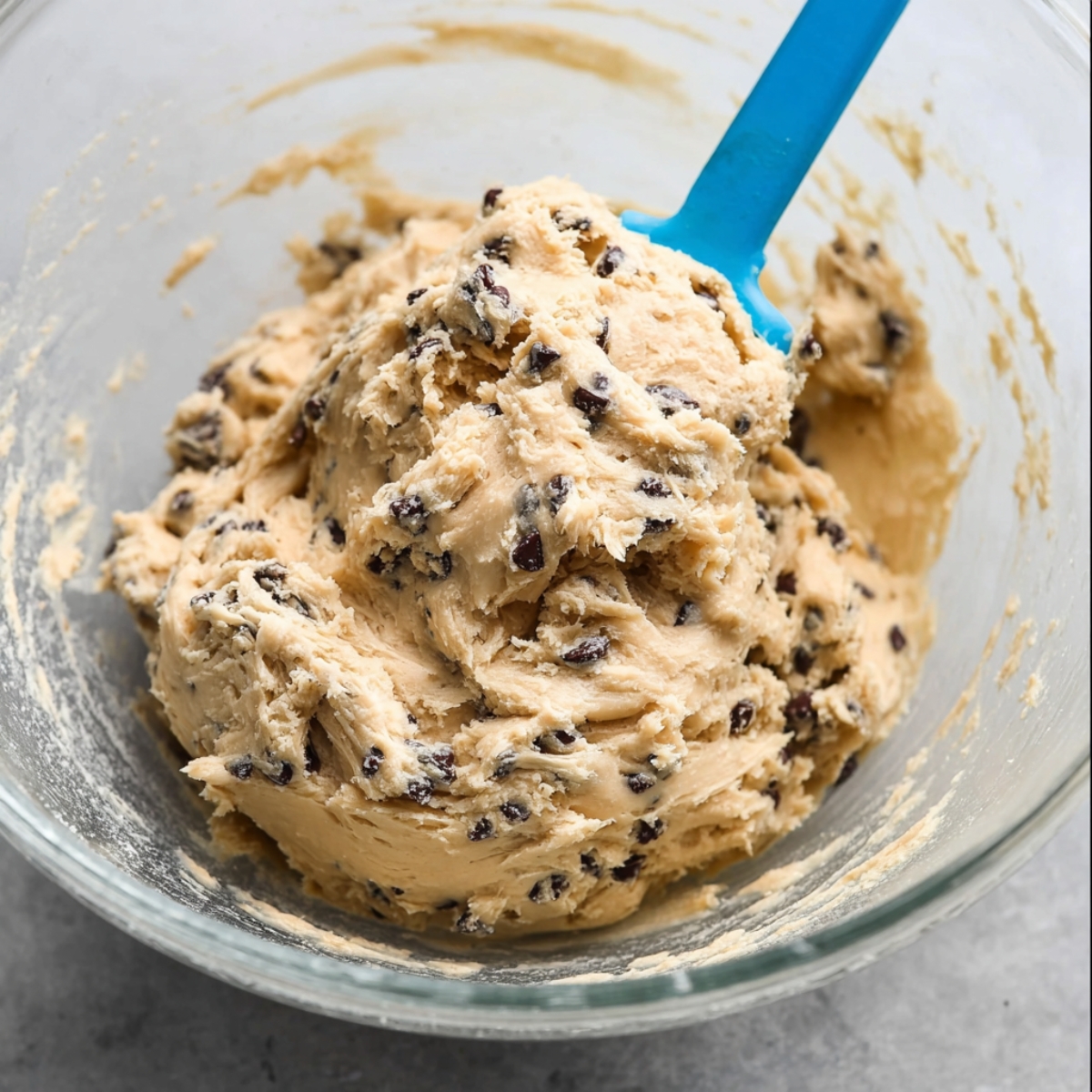 The Best Cookie Dough Brownies Recipe 11 Cookie dough with chocolate chips mixed into a glass bowl.