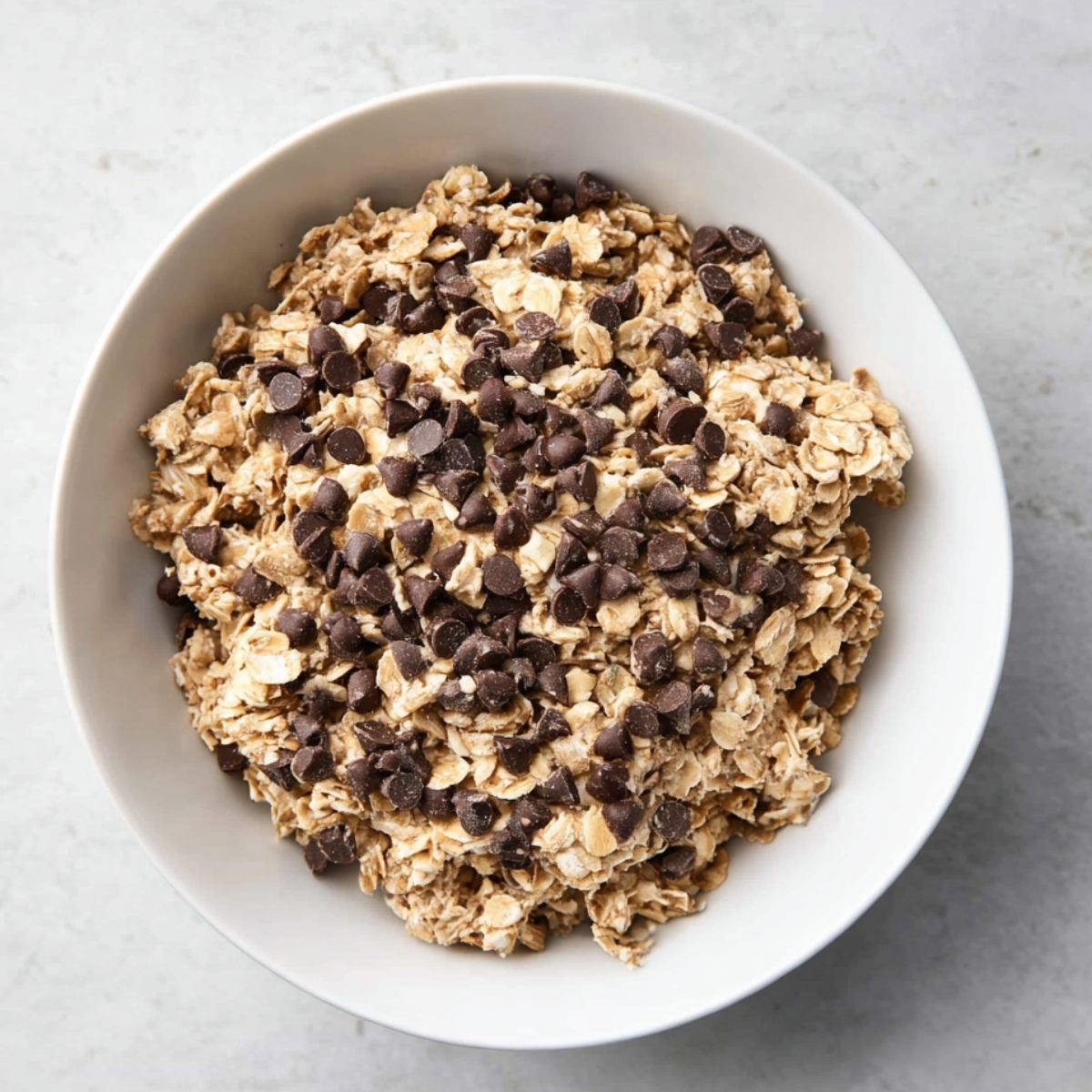 No Bake Peanut Butter Oatmeal Bars 11 Oatmeal mixture with chocolate chips being folded in with a spatula.