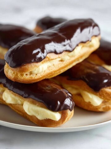 Easy Homemade Eclairs Recipe 6 Homemade Eclairs Recipe filled with smooth pastry cream and topped with a glossy chocolate glaze.