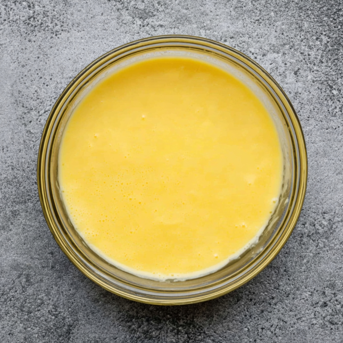 No-Bake Lemon Tiramisu Recipe 10 Bright yellow lemon syrup in a small bowl, smooth and well-mixed.