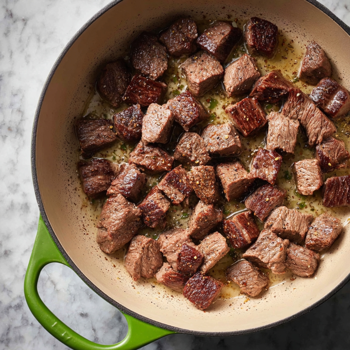 Easy Beef Pot Pie Recipe 10 Beef cubes searing in a Dutch oven.