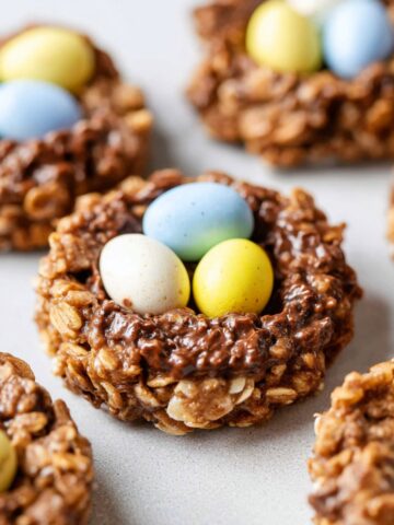 Quick Birds Nest Cookies Recipe 3 Birds Nest Cookies with pastel-colored candy eggs in the center.