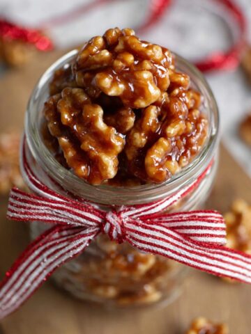 Best Candied Walnuts Recipe 2 Candied Walnuts in a jar, tied with a red-and-white striped ribbon.