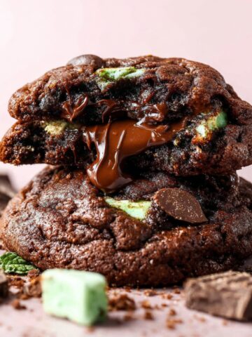 Gooey Chocolate Mint Cookies with melted chocolate spilling from the center.