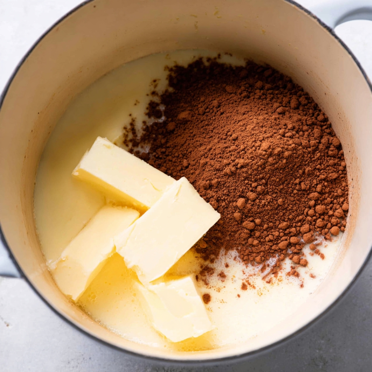 Quick Birds Nest Cookies Recipe 10 Butter and cocoa powder in a pot, ready to be melted together for the cookie base.