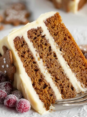 Moist Gingerbread Layer Cake 1 Slice of Gingerbread Layer Cake with frosting and decorations.